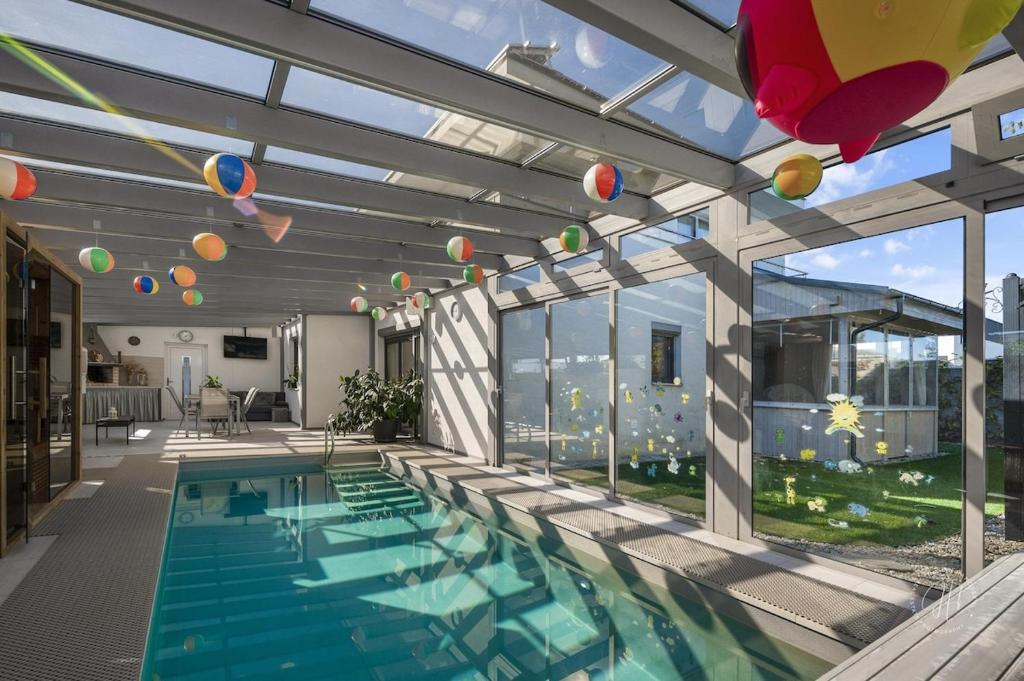 a swimming pool in a house with glass walls at SPA vila na Golfe in Hrubá Borša