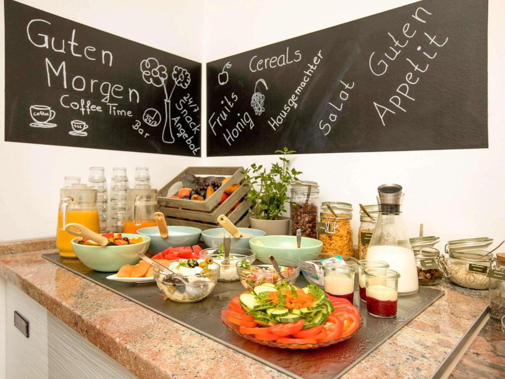 a counter top with a bunch of food on it at ibis Berlin City Süd in Berlin