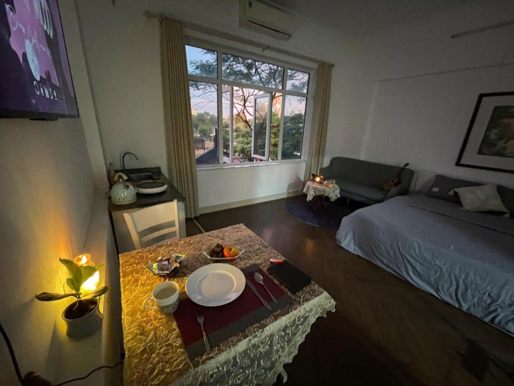 a room with a bed and a table with a plate on it at CHILLING SUDIO 11 Trinh Cong Son close Ho Tay vs Lotte mail ! in Hanoi