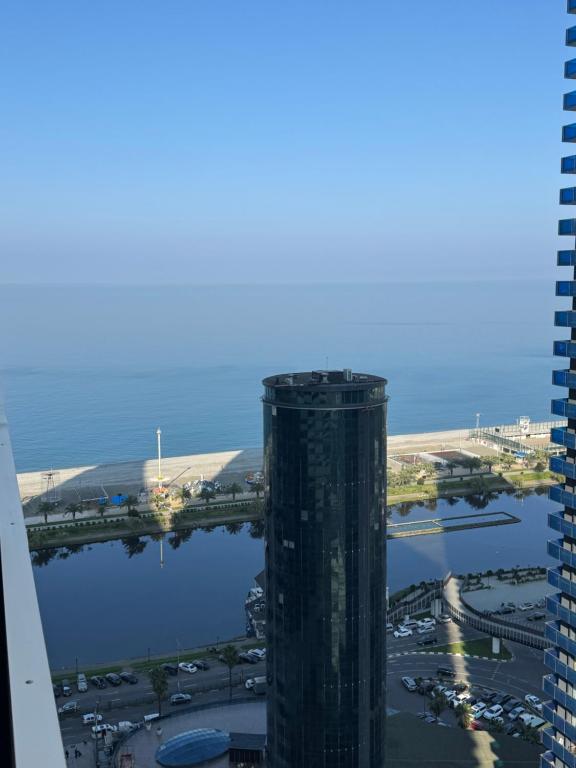 an aerial view of a tall building next to a body of water at Orbi city batumi new in Batumi