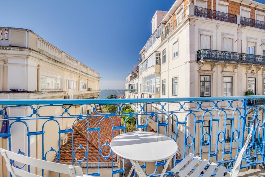 a table and chairs on a balcony with buildings at Chiado 44 in Lisbon
