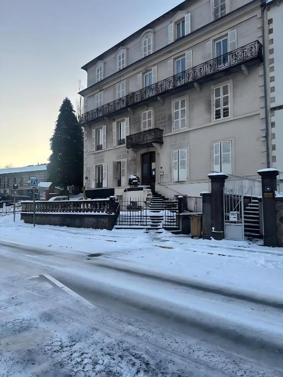 a building with snow on the ground in front of it at Studio 2 personnes in La Bourboule