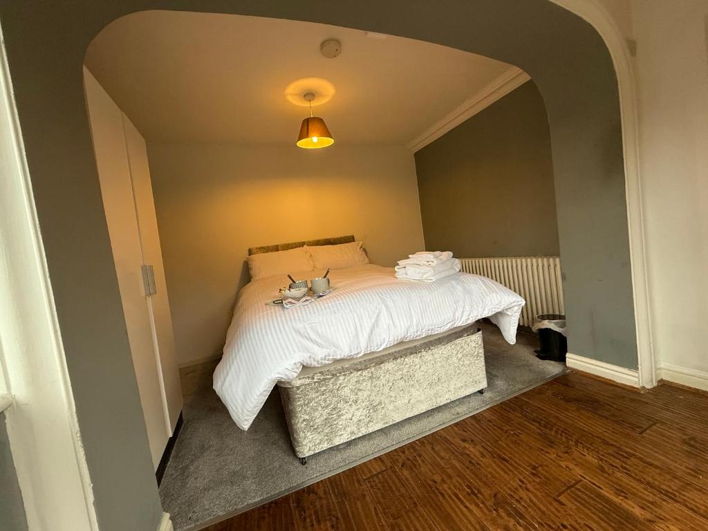a bedroom with a bed with a white comforter at room 02 chesterton Grove in Manchester
