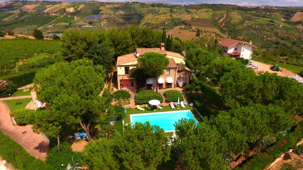 an aerial view of a house with a swimming pool and trees at Villa Vittoria in Citta' Sant'Angelo