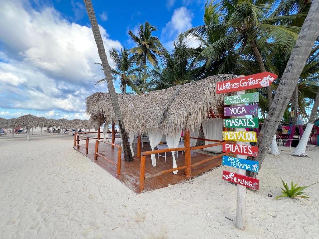 a restaurant on a beach with a sign on it at STUDIOS WITH POOL VIEW - SOL CARIBE TROPICAL - playa LOS CORALES in Punta Cana