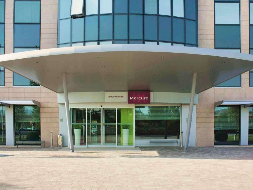 a large office building with a large roof at Hotel Mercure Venezia-Marghera in Marghera