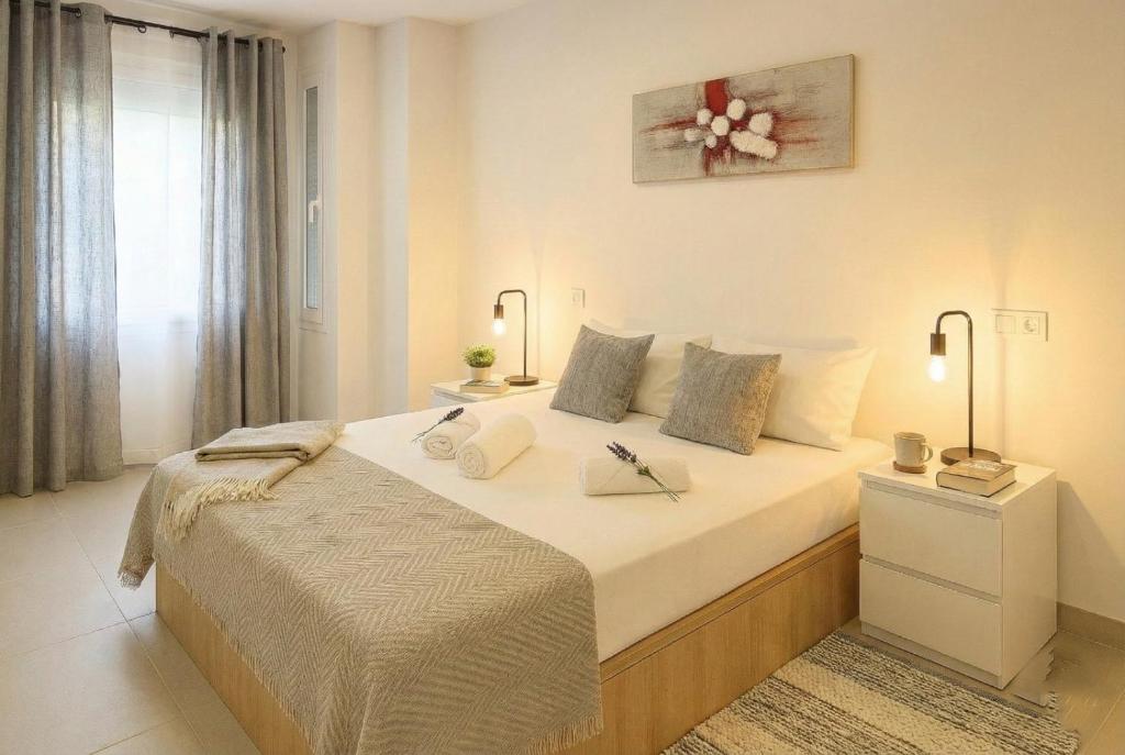 a bedroom with a large bed in a room at Apartamentos Benalua Alicante - Con Parking - Elegir en el momento de la reserva in Alicante
