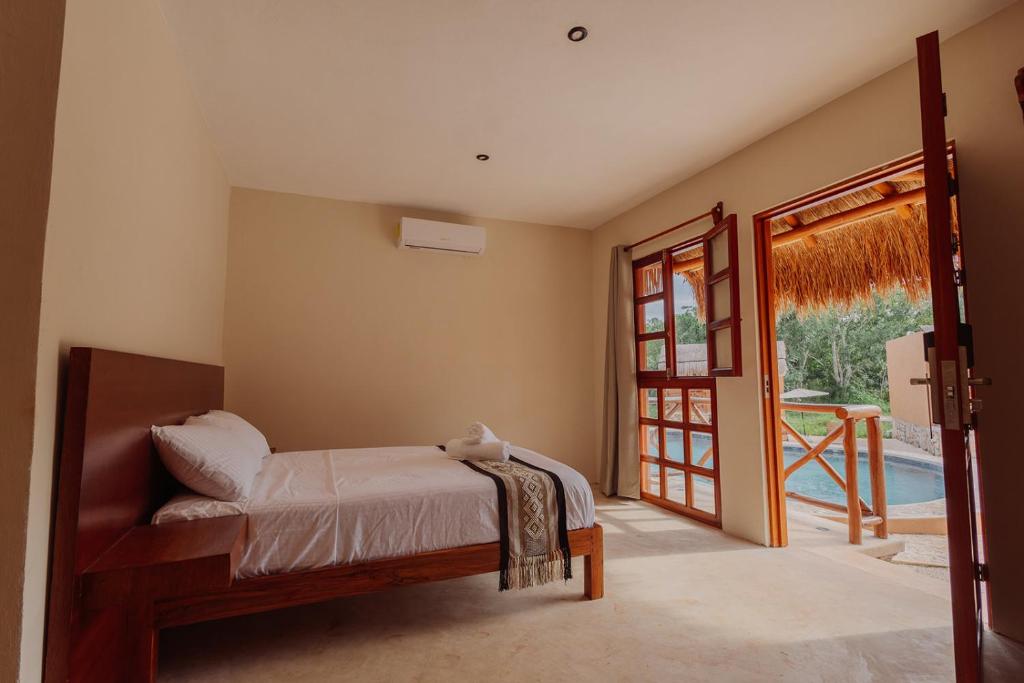 Ένα ή περισσότερα κρεβάτια σε δωμάτιο στο Quietud Hotel