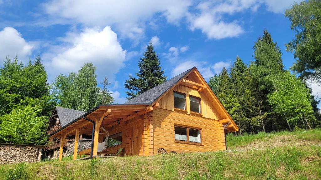 a log home with a gambrel roof at Piernikowa Chata in Zawoja