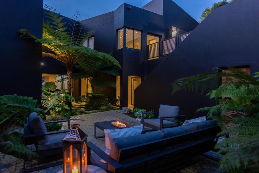 a house with a garden with a couch and a patio at IL Gattopardo in Wilderness