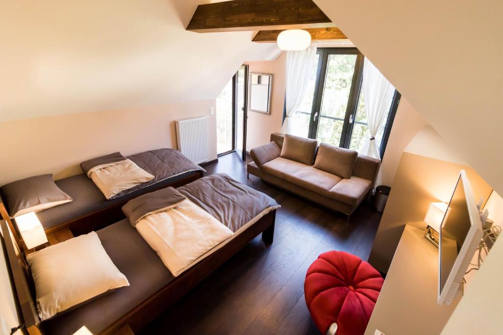 a small bedroom with a bed and a couch at BnB Comfort Guesthouse Olten - Lostorf in Lostorf