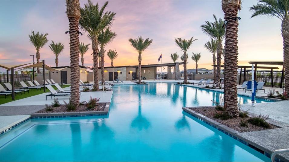 a large swimming pool with palm trees in a resort at BnB Vacation Home in Queen Creek