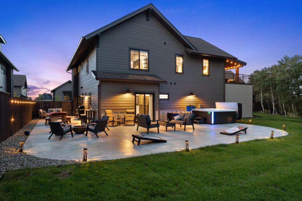 a backyard patio with chairs and a table in front of a house at Alpine Basecamp in Red Lodge