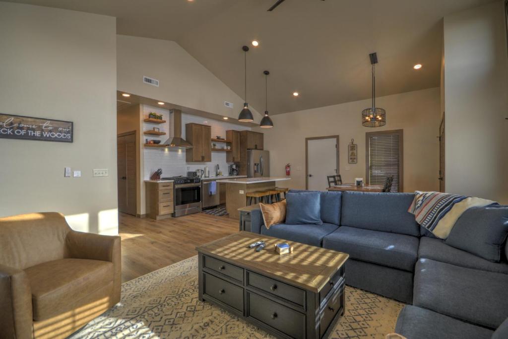 a living room with a blue couch and a kitchen at Ski Run View Red Lodge in Red Lodge