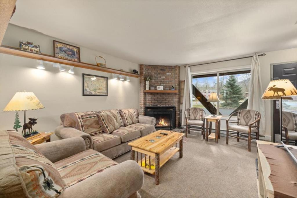 a living room with a couch and a fireplace at Gunslinger Gateway Red Lodge in Red Lodge