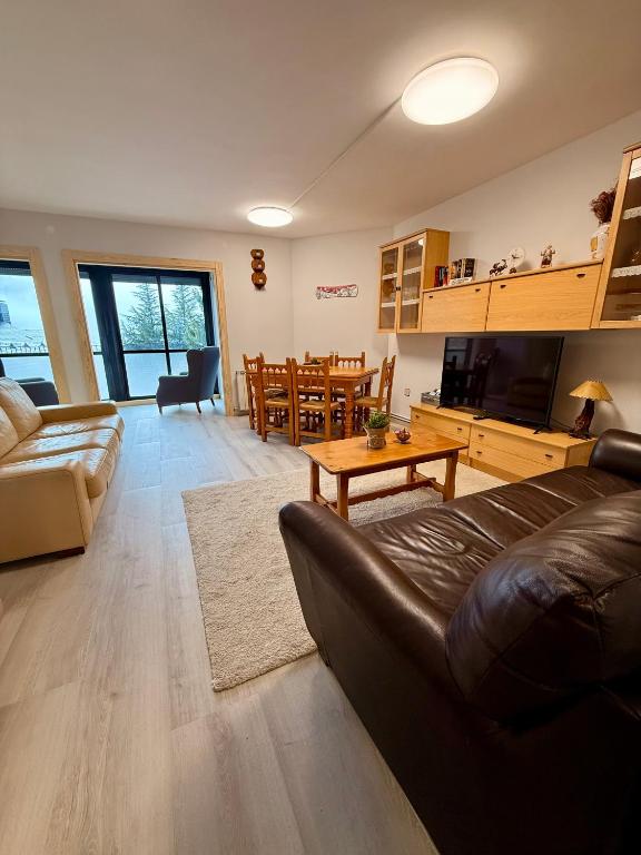 a living room with a couch and a table at Apartamento La Pinada in Tramacastilla de Tena