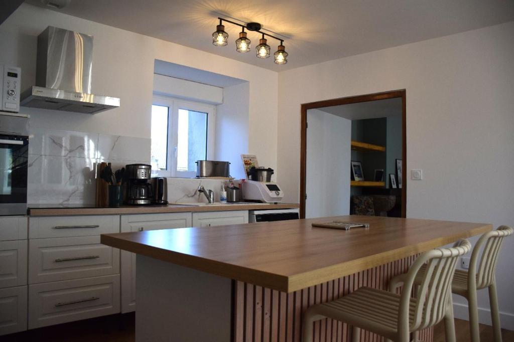 a kitchen with a wooden island in the middle at Ti An Eizh - Charming Townhouse - Near Vannes in Treffléan
