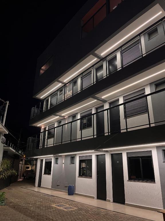 a building with a lot of windows at night at Haven Residence in Uberlândia