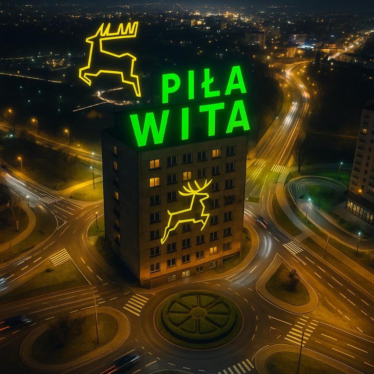 a building with a pizza wilka sign on top of it at Apartament Piła Wita in Piła
