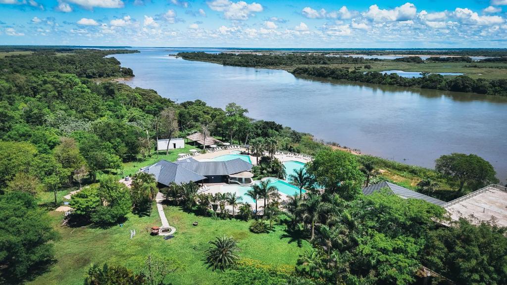 an aerial view of a house next to a river at La Regina Lodge in Itatí