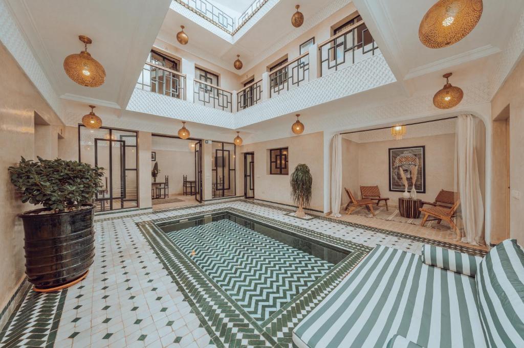 an indoor swimming pool in a house with a ceiling at Riad Valentine in Marrakech