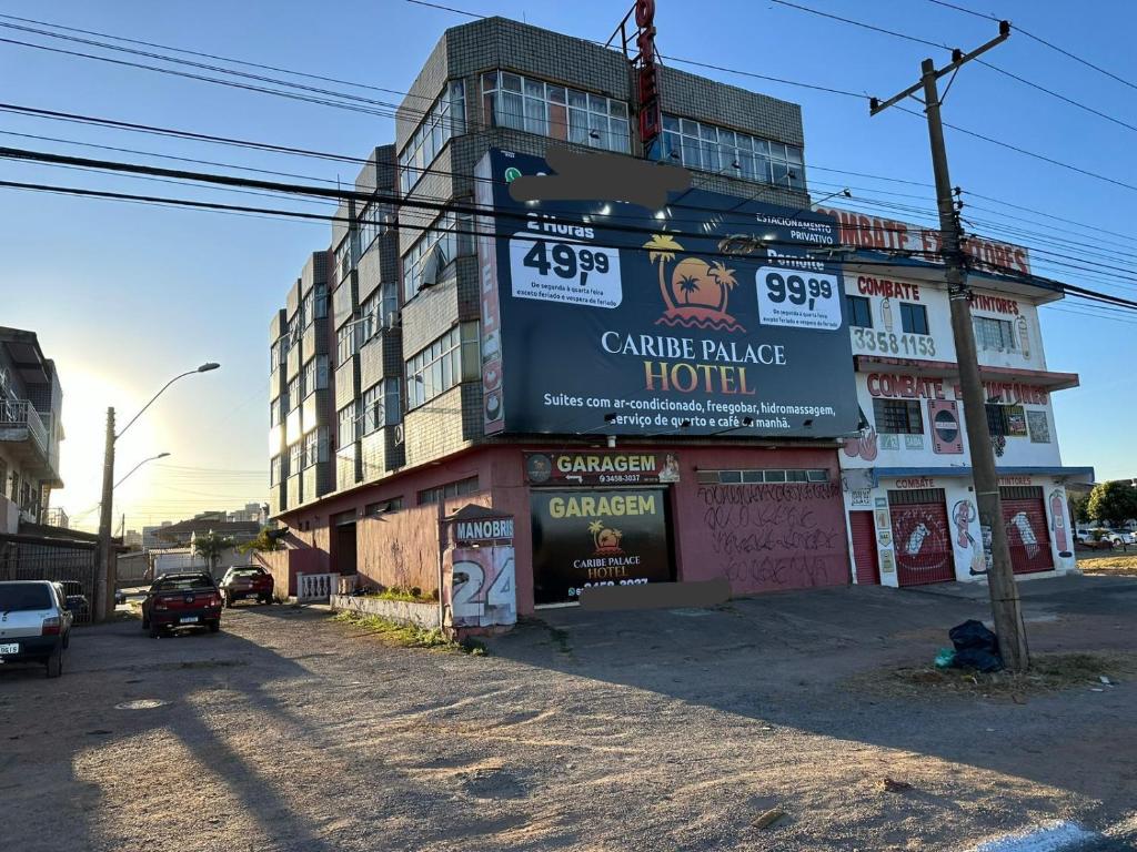 a building with a sign on the side of it at Caribe Palace Hotel Samambaia in Brasilia