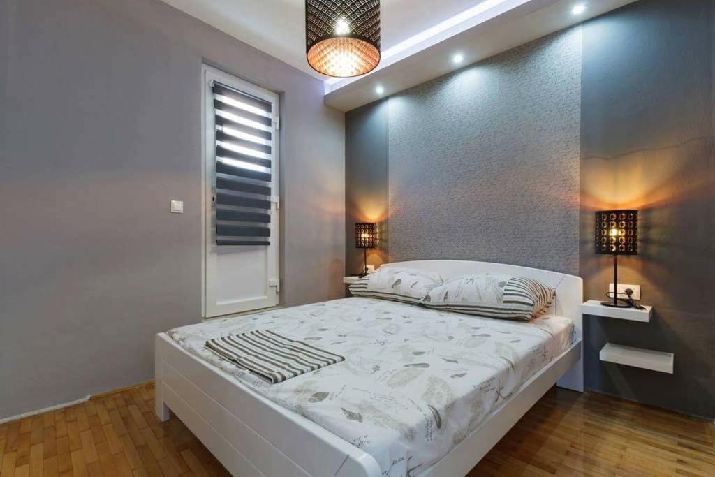 Postel nebo postele na pokoji v ubytování Apartments Romantica