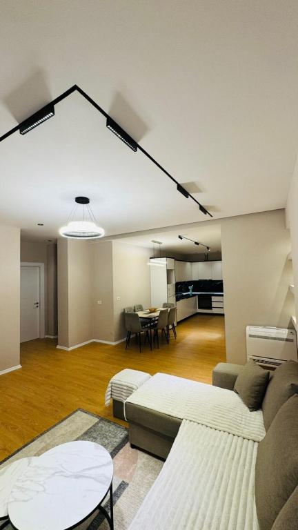 a living room with a couch and a table at Gloria New Bazaar Apartment in Tirana