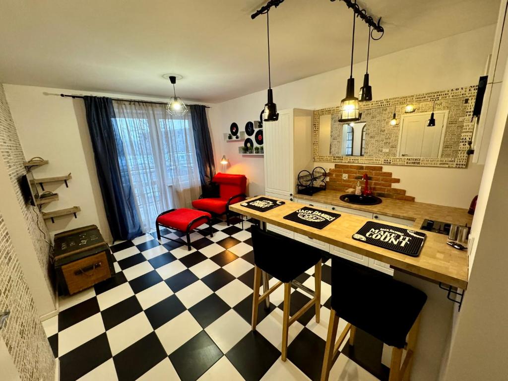 a kitchen with a black and white checkered floor at LOFT Studio Wielicka in Krakow