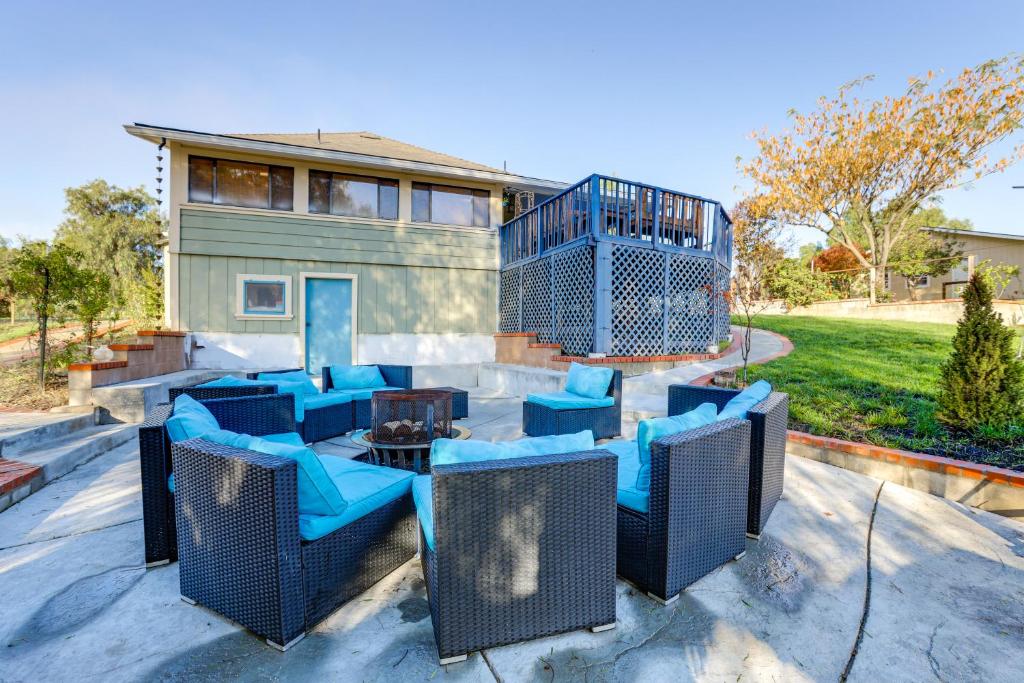 a patio with blue chairs and tables in front of a house at 28 Acres in Wine Country! Central California Oasis in Estrella