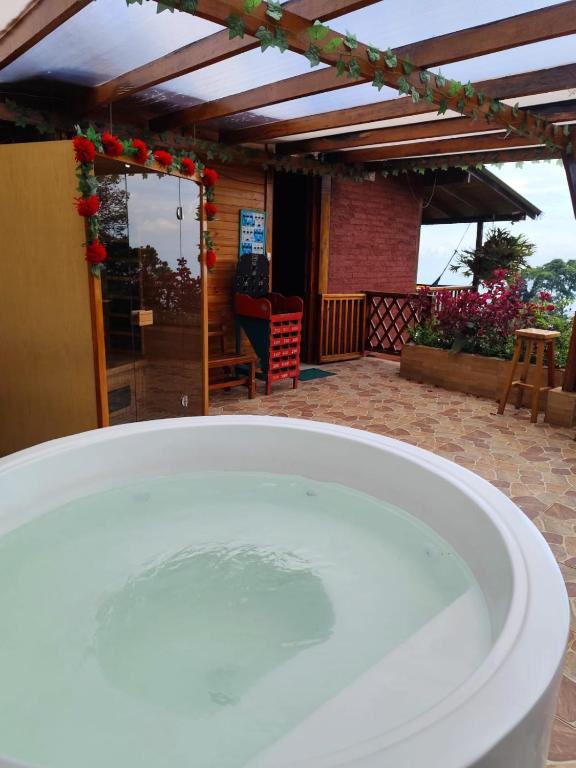 a bath tub sitting in front of a patio at Glamping y Cabañas SPLENDOR VILLA EL EDEN in Cali