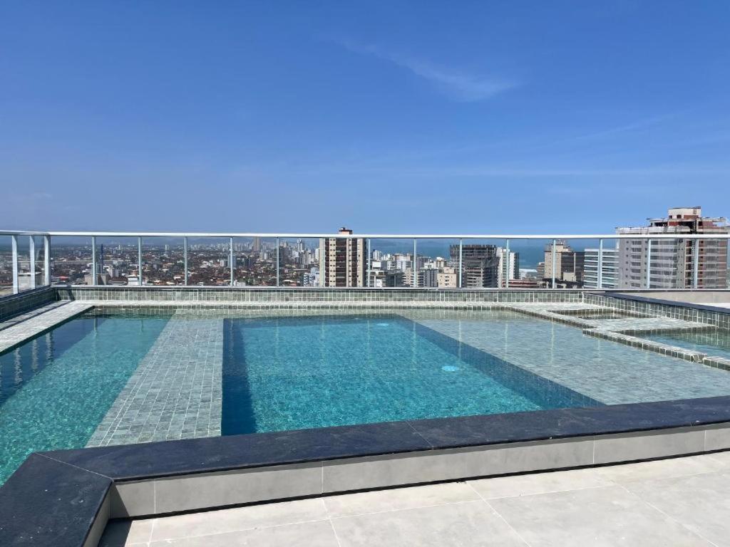 a swimming pool on the roof of a building at Priority Praia grande in Praia Grande