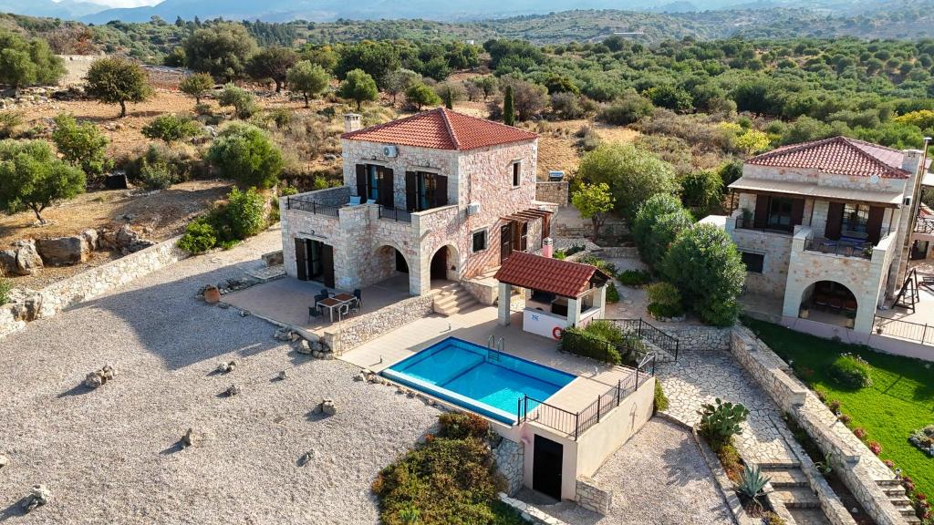 an aerial view of a house with a swimming pool at Villa Petra- Panormic Sea view - Private Pool in Kalyves
