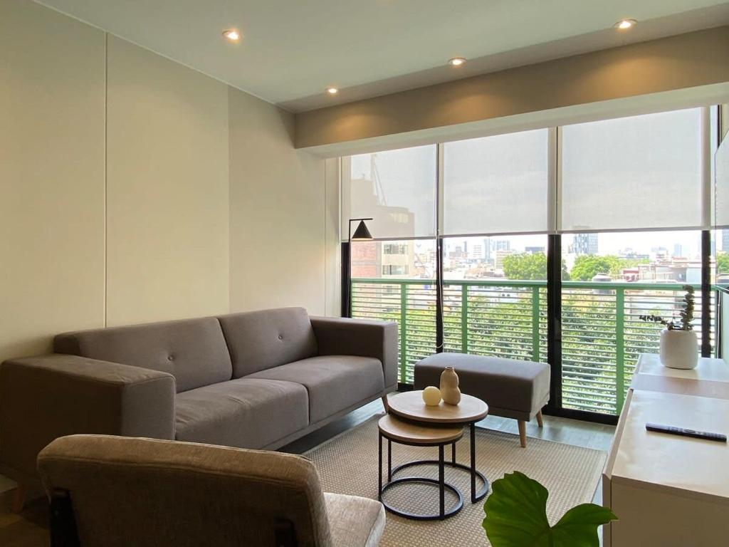 a living room with a couch and a table at Modern 2BR with Balcony in San Isidro in Lima