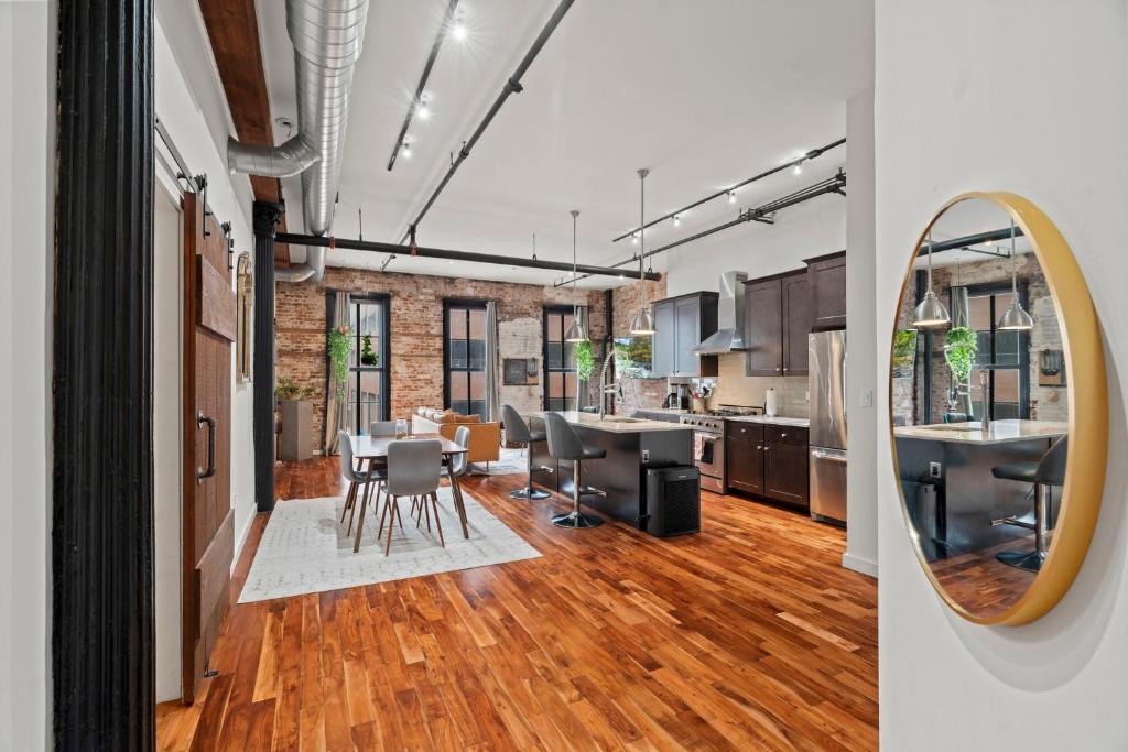 a kitchen and dining room with a table and a mirror at The Founders Suite Residence in Philadelphia