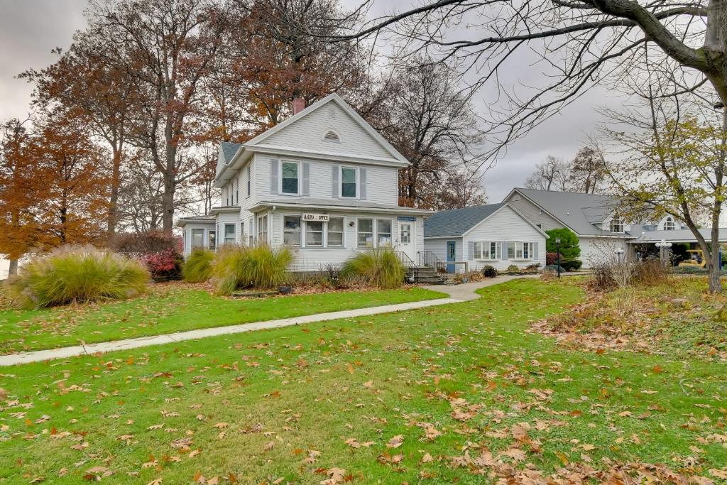 a white house with a lawn and a driveway at Lake Access and Incredible Views at Sodus Bay Home! in North Rose