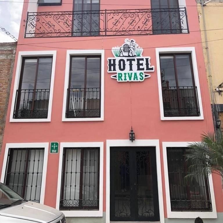 a pink building with a hotel tavern sign on it at Hotel Rivas in Tequila