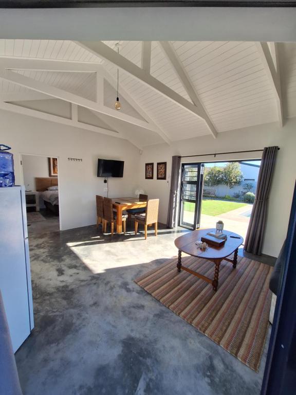 a living room with a table and a dining room at 66onjennings Strand in Strand