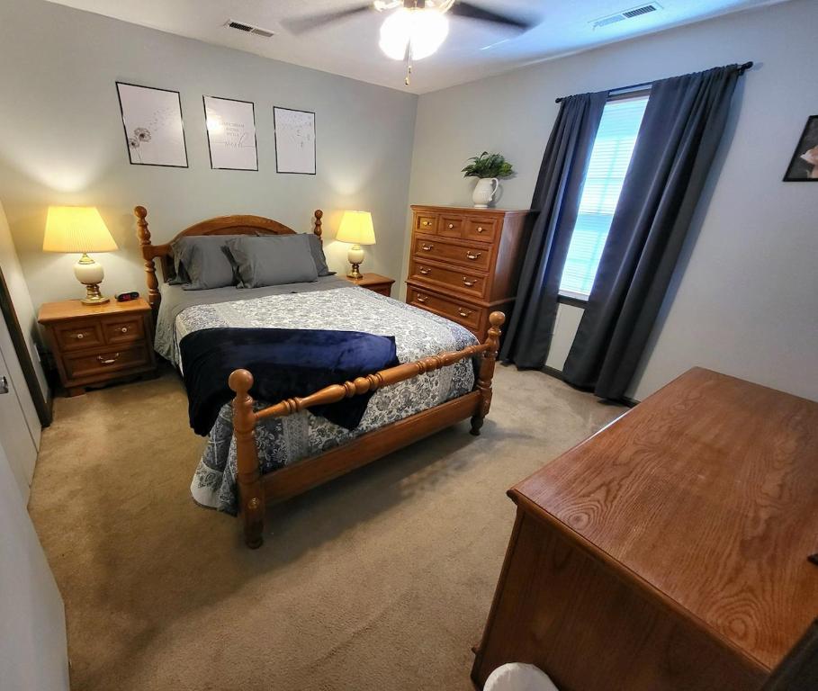a bedroom with a bed and a dresser and a table at Wildwood Estates in Lynchburg