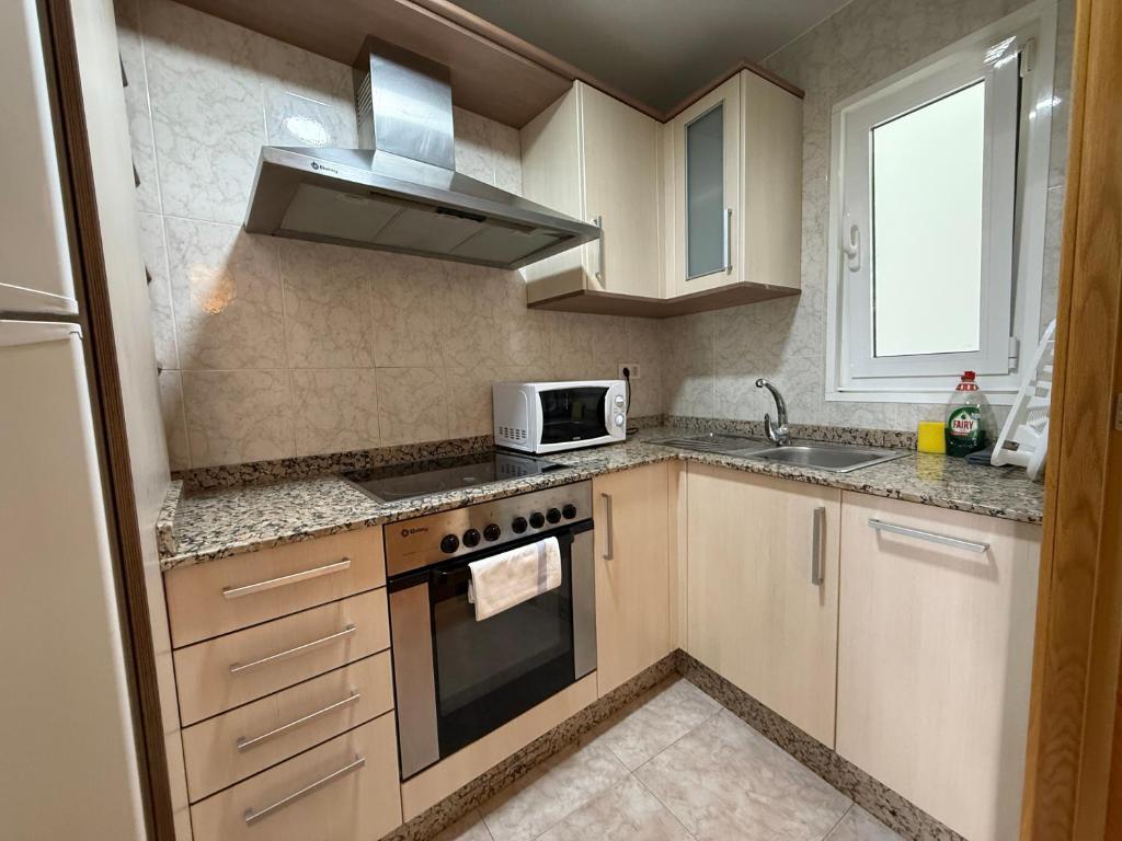 a small kitchen with a stove and a microwave at SP 64 Vut in Lugo