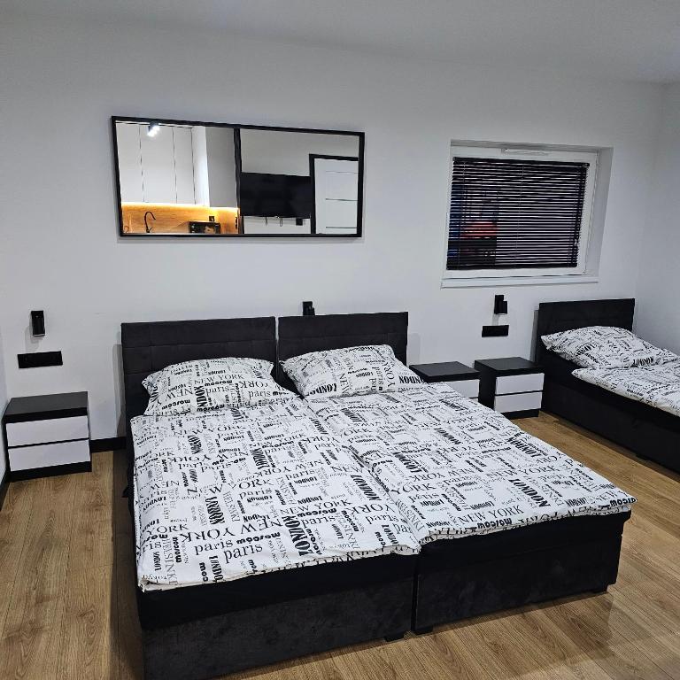 a bedroom with a bed and a mirror on the wall at Anpol in Inowrocław