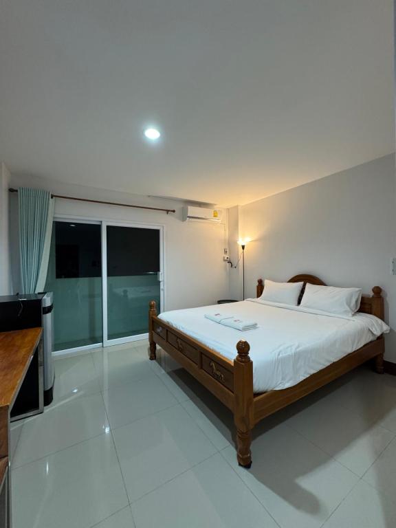 a bedroom with a bed and a television in it at W Smart Stay TRANG in Trang