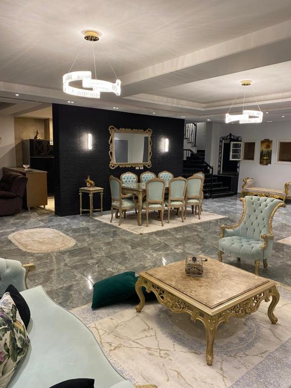 a living room with chairs and a table and a tv at Twin villa for rent in madinaty in Madinaty