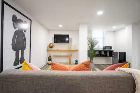 a living room with a couch with orange pillows at Hidden Escape Atlanta Near BENZ ARPT Beltline in Atlanta