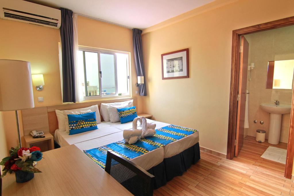 Postel nebo postele na pokoji v ubytování Hotel Santa Maria
