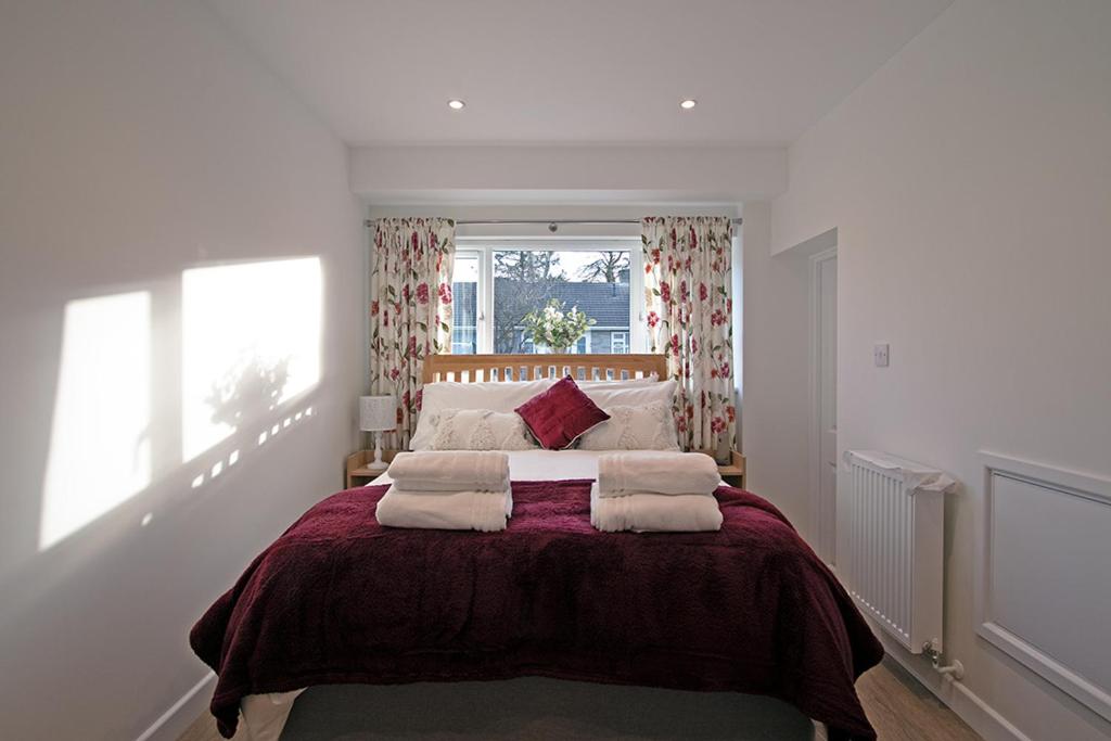 a bedroom with a large bed with towels on it at Cornish Dreams in Camborne
