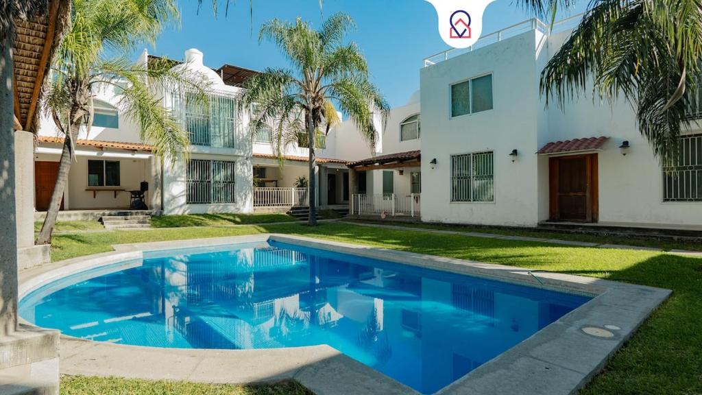 a swimming pool in front of a house at Family House with Pool and Jacuzzi in Morelos in Chiconcuac