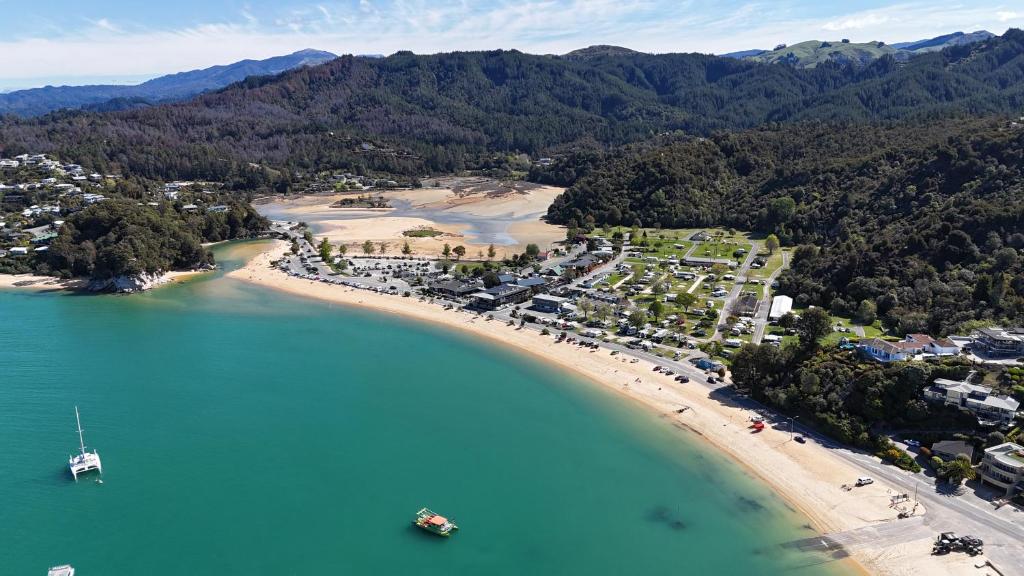 an aerial view of a beach with boats in the water at Kaiteriteri Recreation Reserve Cabins in Kaiteriteri