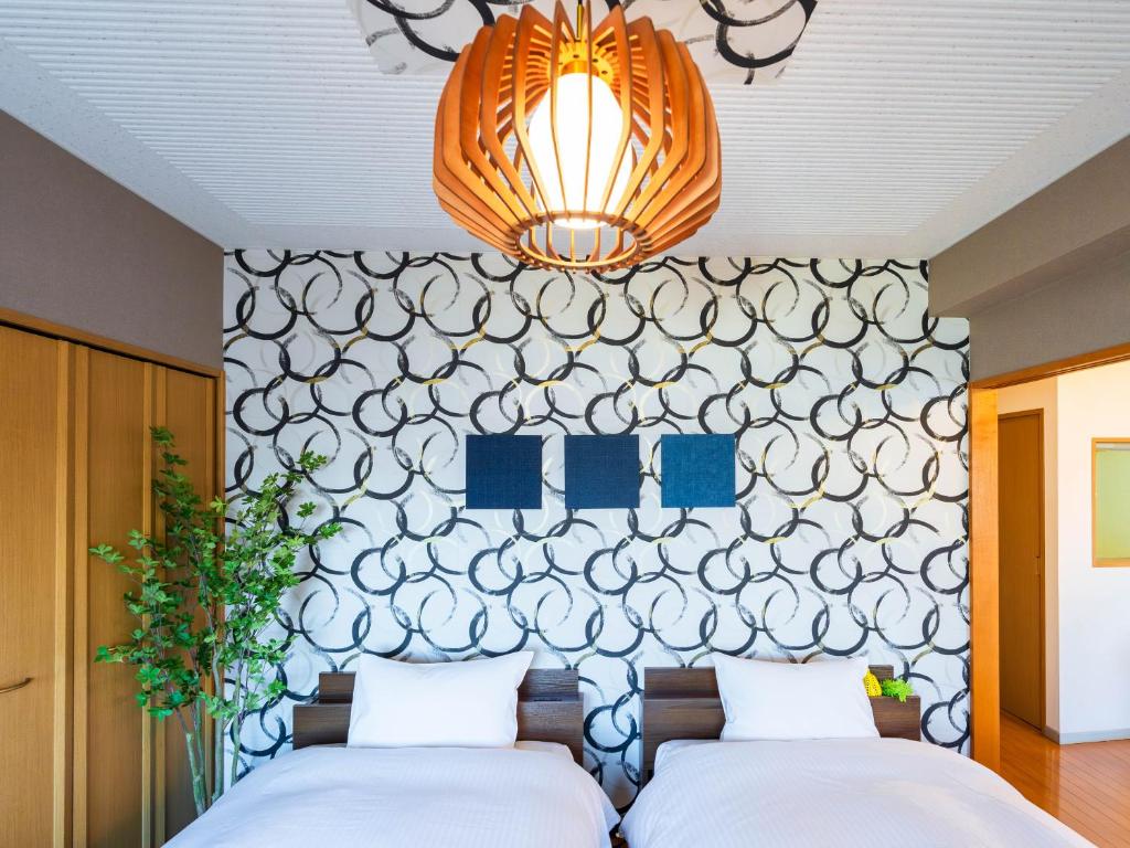 Кровать или кровати в номере MY STORY Familia 801-無料駐車場