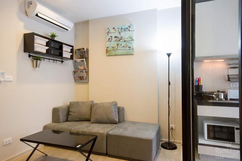 a living room with a couch and a table at The Base 88-67 F5 in Pattaya